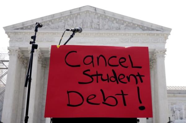 A sign reading "cancel student debt" is seen outside the Supreme Court, Friday, June 30, 2023, in Washington. A sharply divided Supreme Court has ruled that the Biden administration overstepped its authority in trying to cancel or reduce student loans for millions of Americans. Conservative justices were in the majority in Friday's 6-3 decision that effectively killed the $400 billion plan that President Joe Biden announced last year. (AP Photo/Mariam Zuhaib)