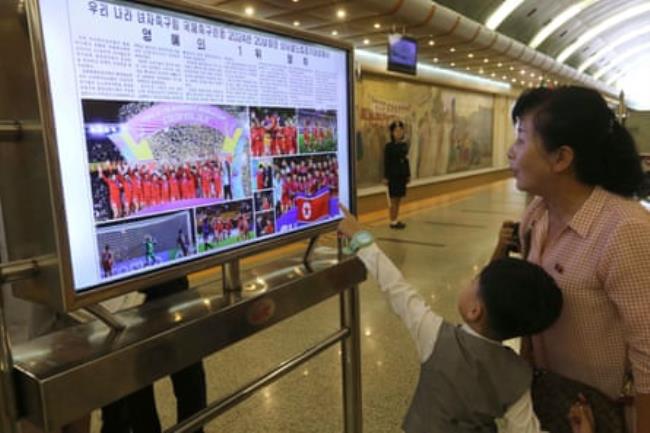 Pyongyang citizens at the Kaeson metro station read about the Chollima’s triumph in Colombia